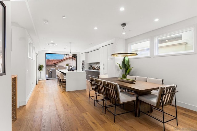 dining area with light hardwood / wood-style floors