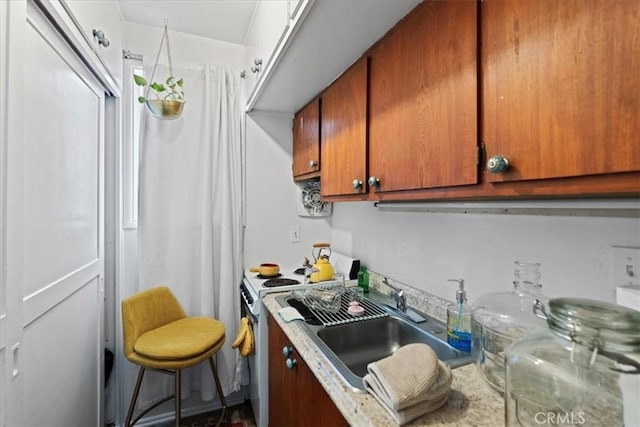 kitchen featuring sink and white stove