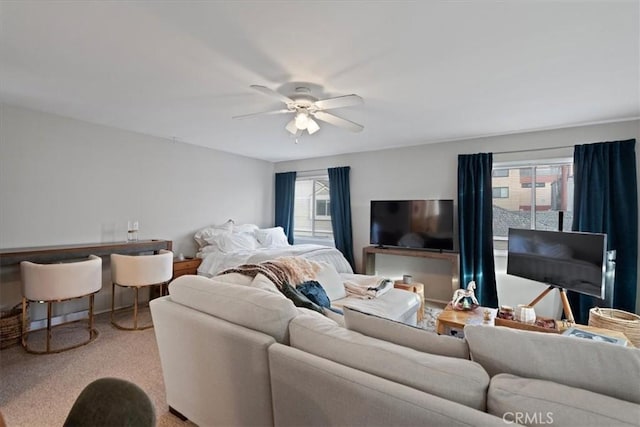 carpeted living room featuring ceiling fan