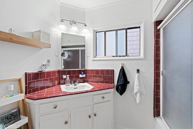 bathroom featuring vanity, an enclosed shower, and crown molding