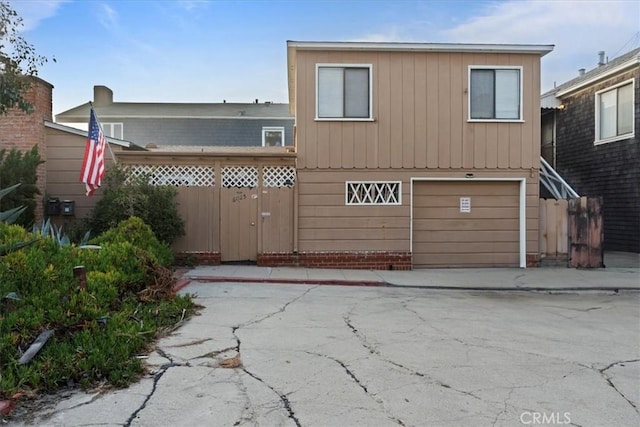 rear view of house with a garage