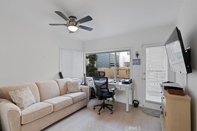 home office with ceiling fan, a healthy amount of sunlight, and light wood-type flooring