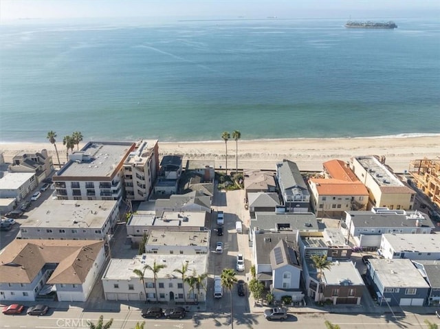 birds eye view of property featuring a beach view and a water view