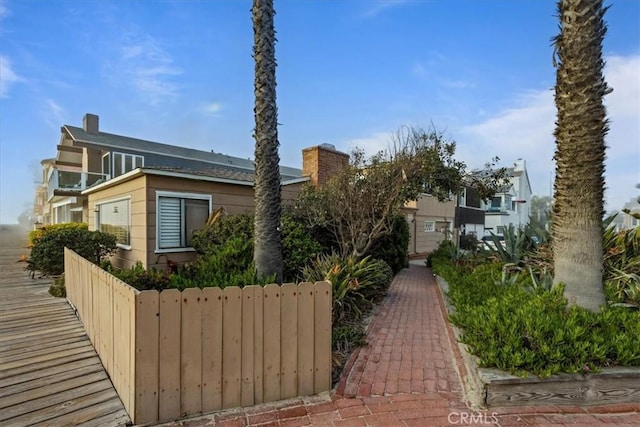 view of front of house featuring fence and a chimney