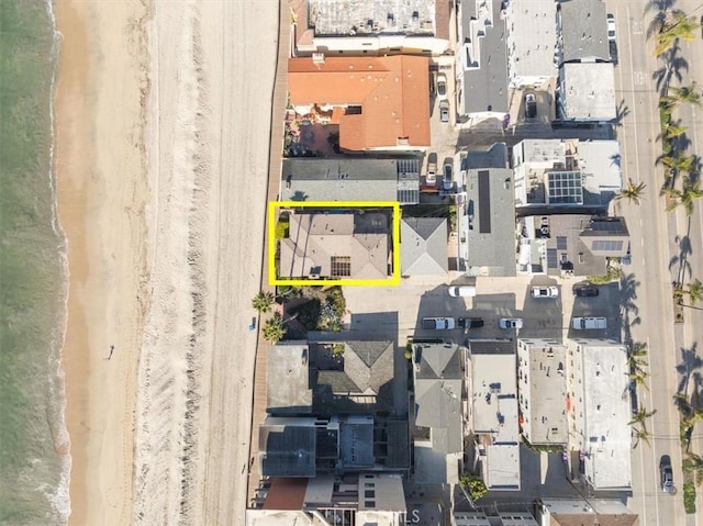 drone / aerial view featuring a water view and a view of the beach