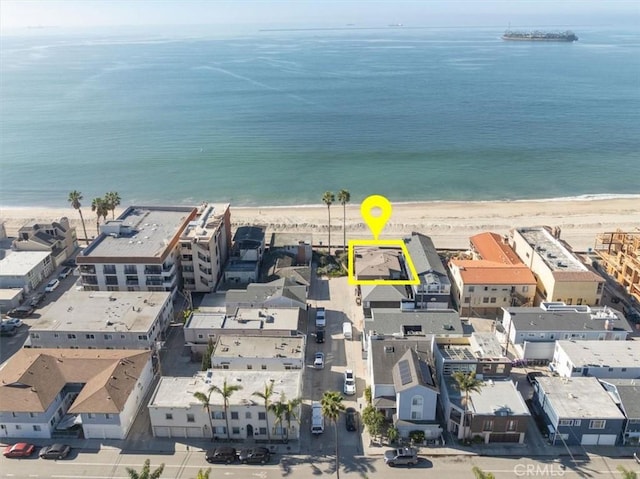 aerial view featuring a view of the beach and a water view