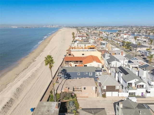 birds eye view of property featuring a water view, a residential view, and a view of the beach