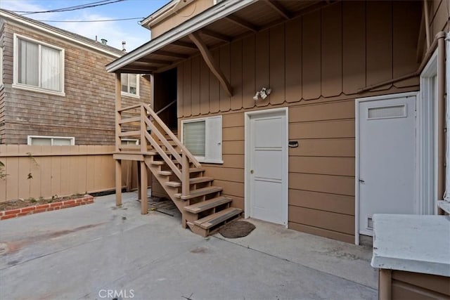 property entrance with a patio area and fence