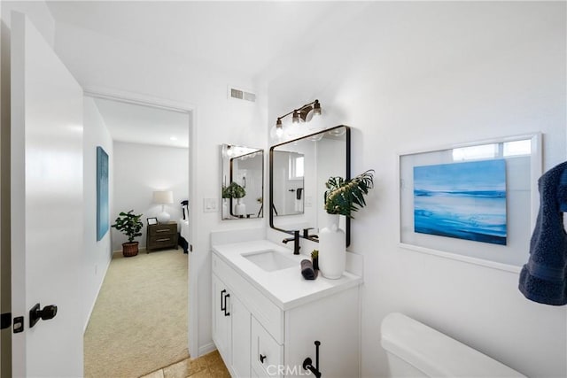 bathroom with vanity and toilet