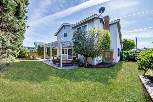 back of house featuring a patio, outdoor lounge area, a pergola, and a lawn