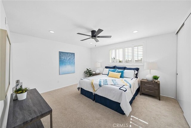 bedroom featuring ceiling fan and light colored carpet