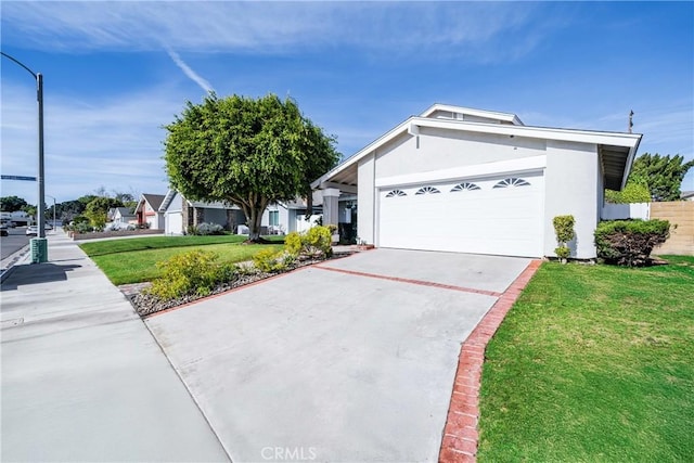 ranch-style house featuring a garage and a front yard