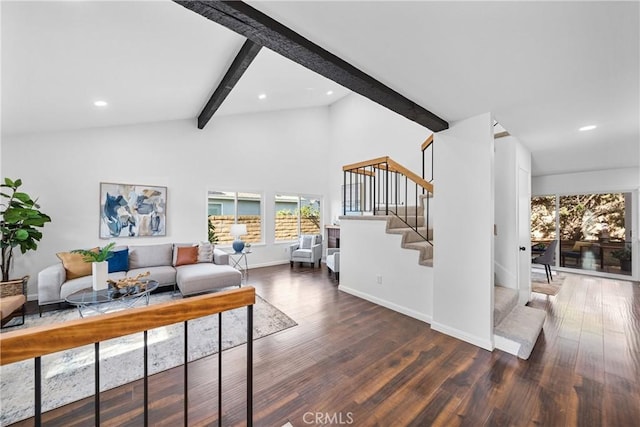 living room featuring dark wood-type flooring and vaulted ceiling with beams