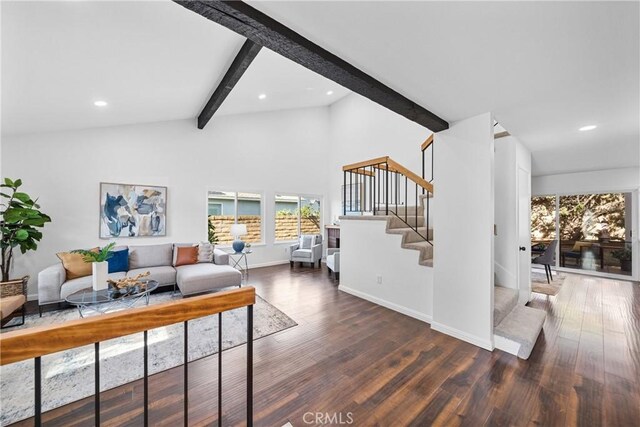 living room featuring lofted ceiling with beams and dark hardwood / wood-style floors