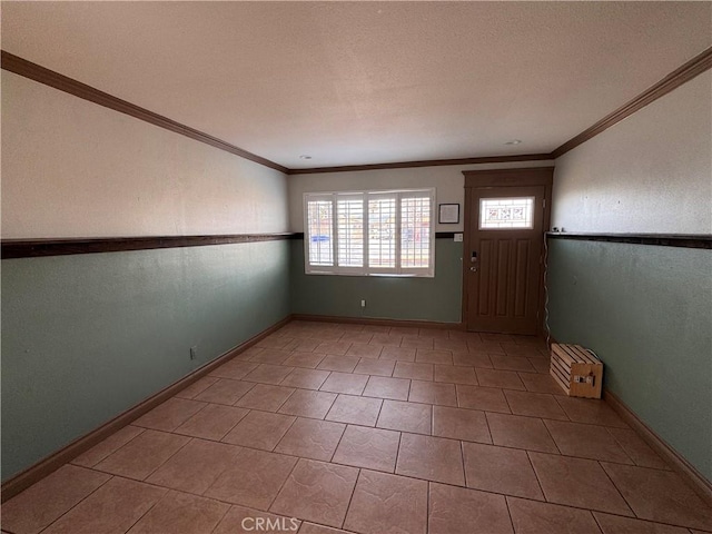 entryway featuring crown molding and light tile patterned flooring