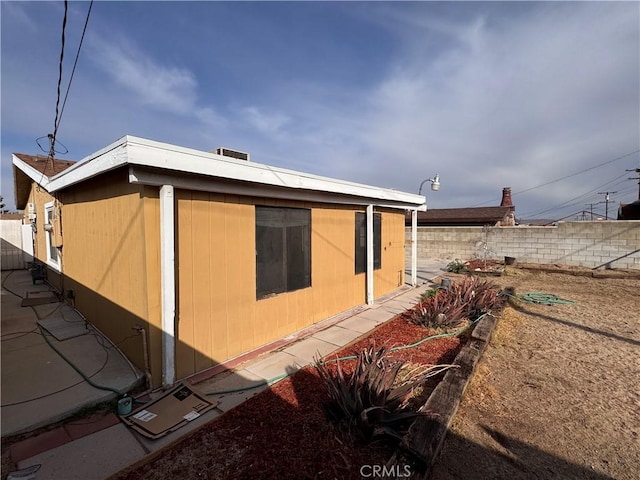 view of side of home featuring ac unit