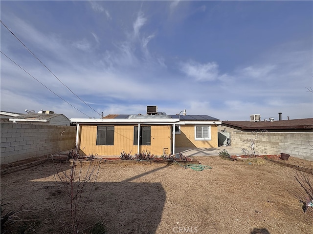 1704 Sunrise Rd, Barstow, CA 92311 - back of house with a fenced backyard and solar panels