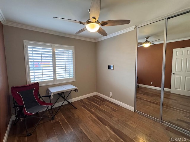 sitting room with crown molding, dark hardwood / wood-style floors, and ceiling fan