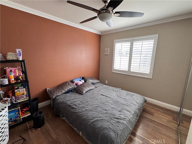 bedroom featuring crown molding, ceiling fan, and wood-type flooring