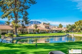 view of property's community featuring a water view and a yard