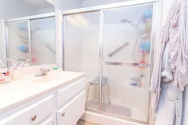 bathroom featuring walk in shower and vanity