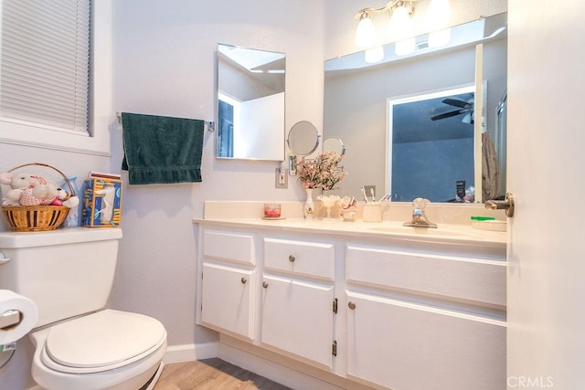 bathroom with vanity, toilet, and wood-type flooring