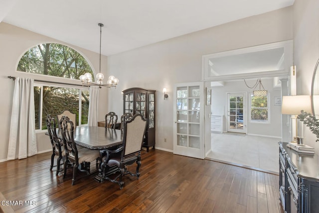 dining space featuring an inviting chandelier and dark hardwood / wood-style floors