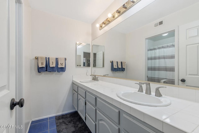 bathroom featuring tile patterned flooring and vanity