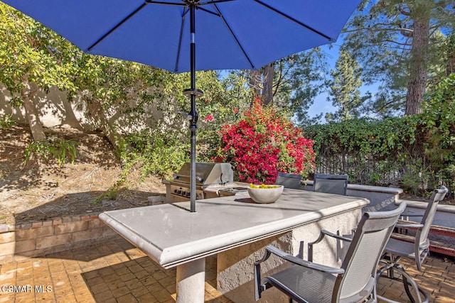 view of patio featuring an outdoor kitchen, a grill, and exterior bar