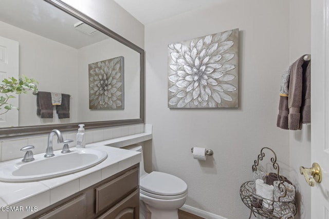 bathroom with vanity and toilet