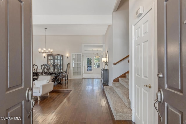 entryway featuring a notable chandelier, dark hardwood / wood-style floors, and beamed ceiling