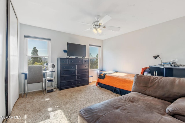 bedroom featuring multiple windows and ceiling fan