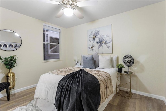 bedroom with light hardwood / wood-style floors and ceiling fan