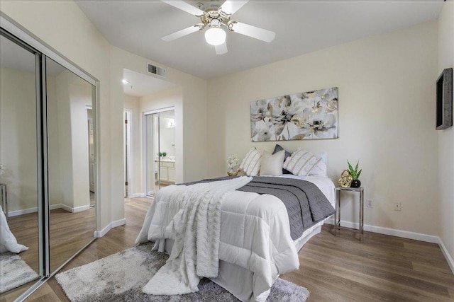 bedroom with ensuite bath, wood-type flooring, a closet, and ceiling fan