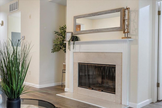 details featuring a premium fireplace and hardwood / wood-style floors