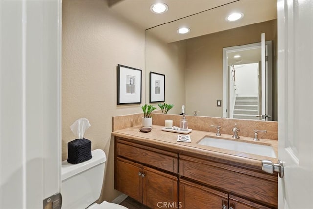 bathroom featuring vanity and toilet