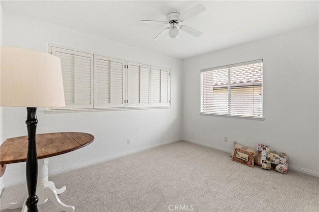 interior space with light carpet and ceiling fan