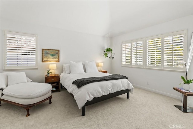 carpeted bedroom with lofted ceiling