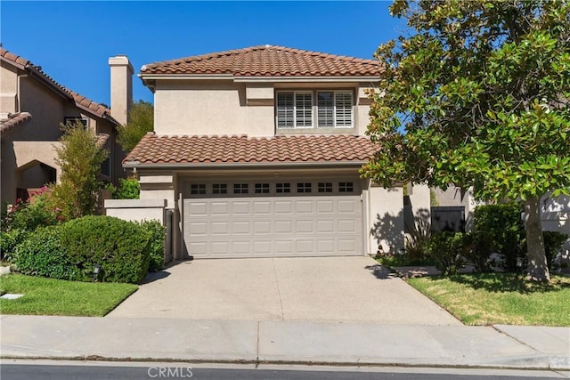 mediterranean / spanish house with a garage