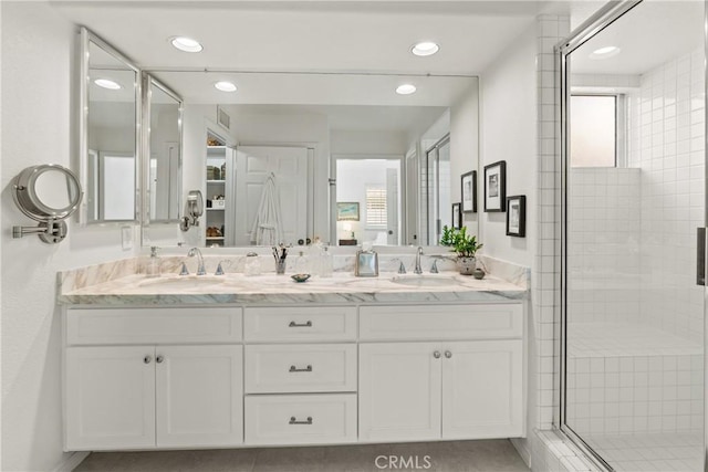 bathroom with an enclosed shower and vanity