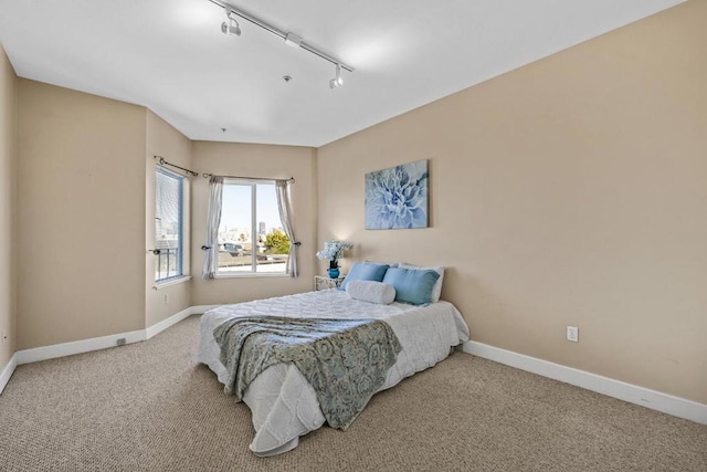 bedroom with carpet flooring and rail lighting