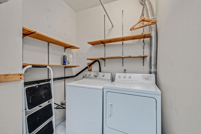 clothes washing area with separate washer and dryer