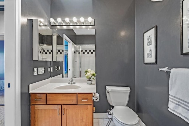 bathroom featuring tile patterned floors, vanity, and toilet