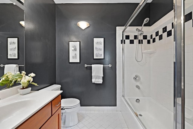 full bathroom with tile patterned floors, toilet, combined bath / shower with glass door, and vanity