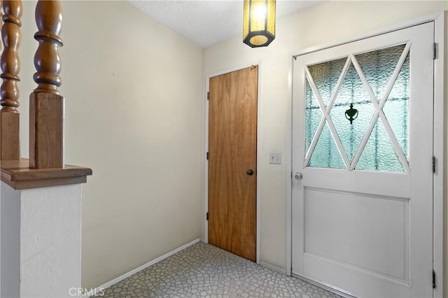 entryway featuring a textured ceiling