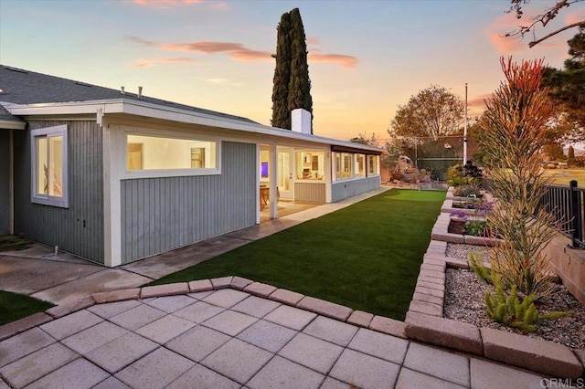 back of house with a yard, a patio, and fence