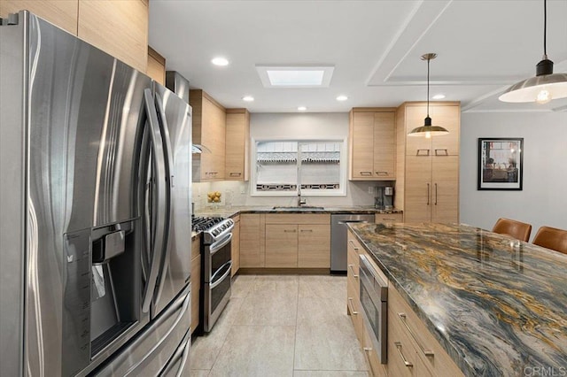 kitchen featuring light brown cabinets, dark stone counters, recessed lighting, stainless steel appliances, and decorative light fixtures