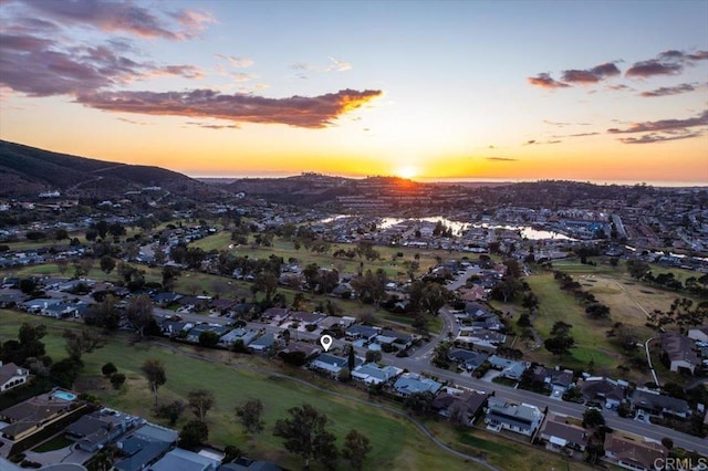 aerial view at dusk featuring a residential view