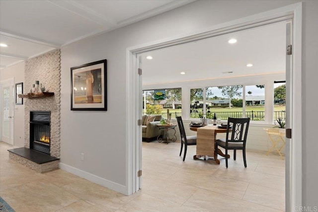 dining room featuring light tile patterned floors, a stone fireplace, recessed lighting, and baseboards