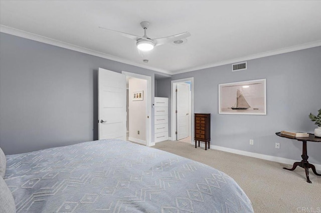 carpeted bedroom with visible vents, baseboards, a ceiling fan, and crown molding